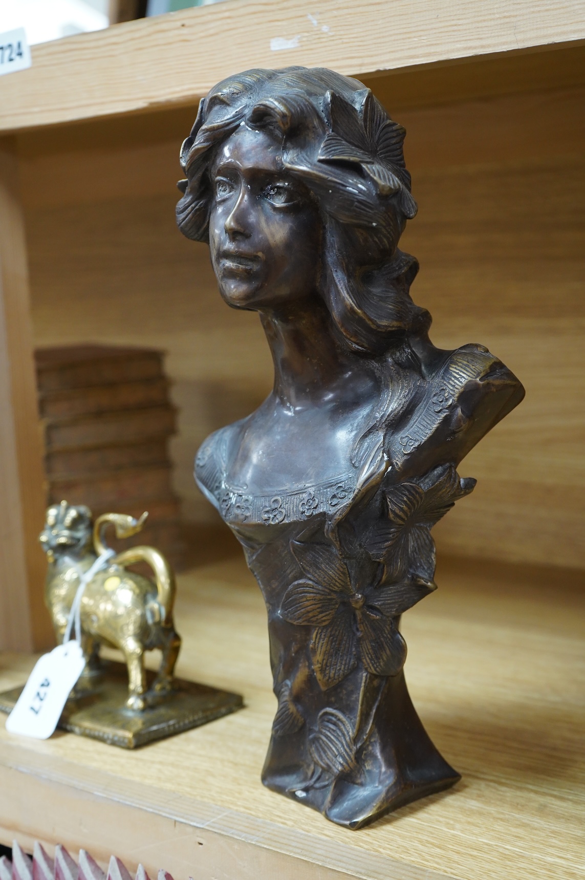 A French Art Nouveau bronze bust of a maiden, unsigned, 32cm high